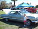 1992 Ford Bronco - A young girl stands next to a classic 1963 Chevrolet Impala at a car show.