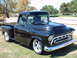 1992 Ford Bronco - This customized black Chevrolet pickup truck, likely from 1955, features a prominent hood scoop and chrome wheels.