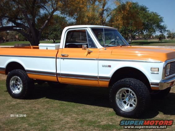 1971 Chevrolet C10 pickup truck, two-tone orange and white paint, lifted suspension, aftermarket wheels