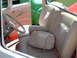 1992 Ford Bronco - Interior view of a car's tan seats and steering wheel, with other vehicles seen through the window.