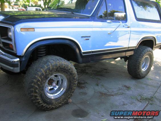 1986 Ford Bronco, blue and black, lifted with large tires