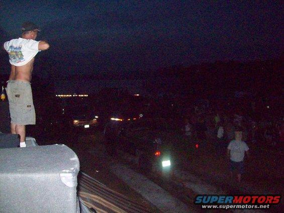 Night scene with crowd and distant vehicles