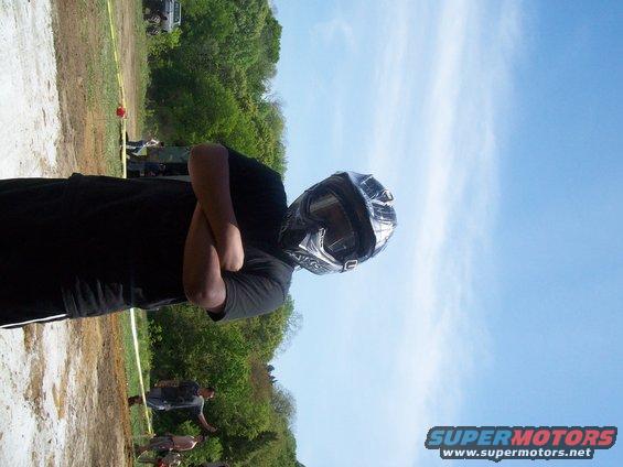 Person in helmet and goggles with arms crossed
