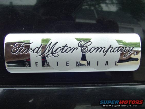 Ford Motor Company Centennial badge on black surface