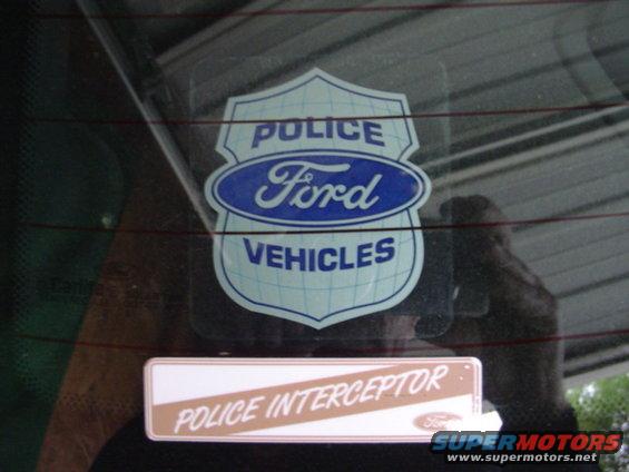Ford Police Vehicles shield decal and Police Interceptor badge on a car's rear window