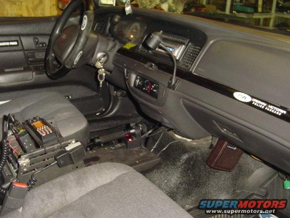 Interior of a 2003 Ford Crown Victoria police car with radios and equipment