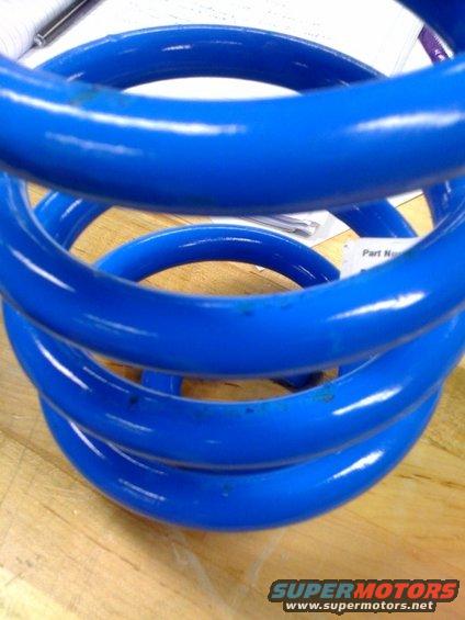 Blue coil spring with 'Part N' visible on a label underneath