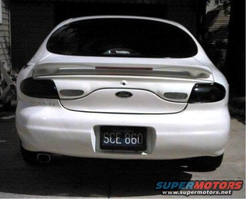 White 1997 Ford Taurus rear view, license plate SCE 860, spoiler, tinted taillights
