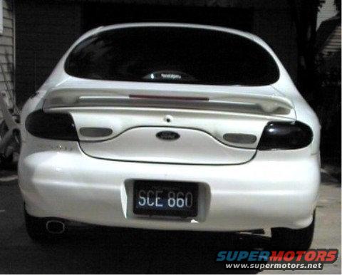 White 1997 Ford Taurus rear view with tinted taillights and spoiler
