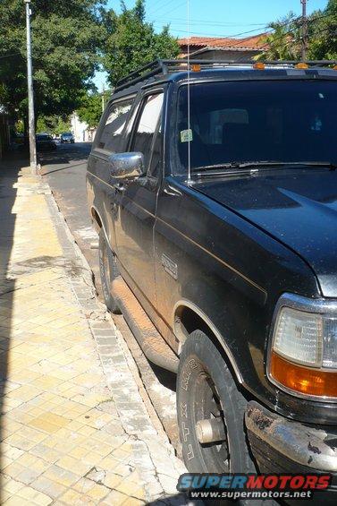 Black 1992 Ford Bronco parked on a street, side view