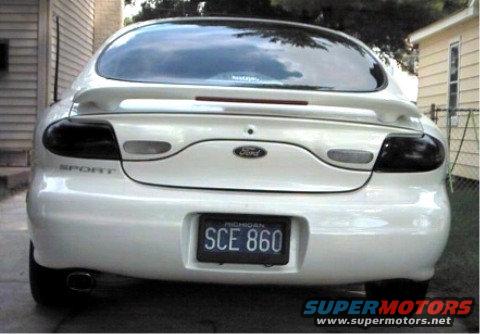 1997 Ford Taurus rear view, white paint, tinted taillights, Michigan plate SCE 860