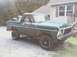1979 Ford Bronco - This green Ford Bronco is parked in front of a house with a gravel driveway and a wooden porch.