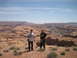 1986 Ford Bronco II - Two men overlook a wide canyon landscape with a river winding through it. Supermotors.net logo is present.