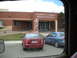 1986 Ford Bronco II - Albert R. Lyman Middle School entrance with two cars parked in the lot.