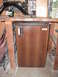 1991 Ford Bronco - A woodgrain-finished Avanti mini-fridge sits under a workbench.