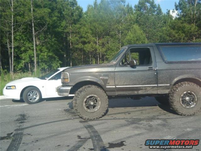 Side view of a lifted 1994 Ford Bronco with large tires