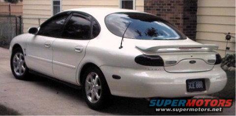 White 1997 Ford Taurus rear view with spoiler and license plate SCE 660