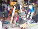 2010 Kawasaki BAYOU 220 - A disassembled motorcycle engine sits on the floor of a cluttered garage, surrounded by tools and equipment.