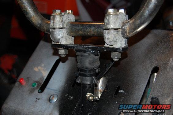 Handlebar assembly with metal clamps and rubber boot