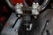 2010 Kawasaki BAYOU 220 - Close-up view of a handlebar assembly with visible bolts and a rubber boot.