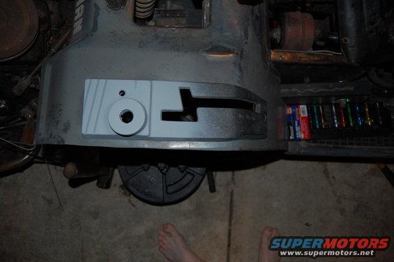 Gray machine part with circular hole and T-slot