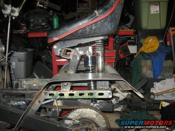 Seat and frame of an ATV, showing suspension and chain drive