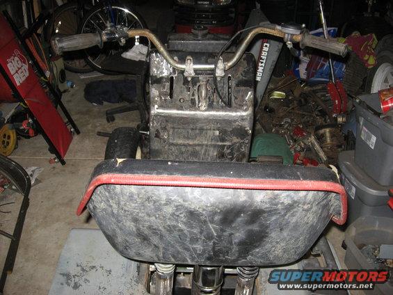 Front view of a Craftsman lawn tractor in a cluttered garage