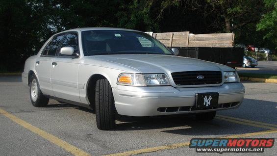 Silver 2000 Ford Crown Victoria sedan, front 3/4 view, parked on asphalt