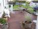 2006 Ford E350 - A backyard patio scene includes outdoor furniture, a grill, and landscaping.