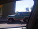 1986 Ford Bronco - This 1986 Ford Bronco, seen from the side, is a two-tone green and tan SUV.