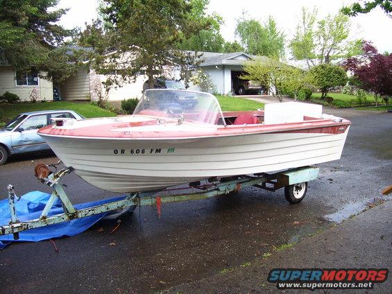 White and red boat on a trailer with license plate OR 606 FM