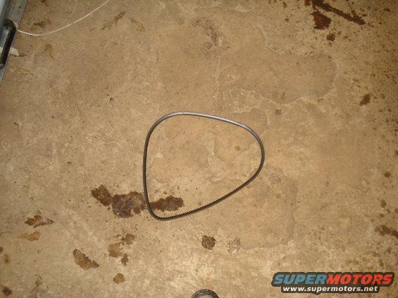 Engine belt lying on a stained concrete floor