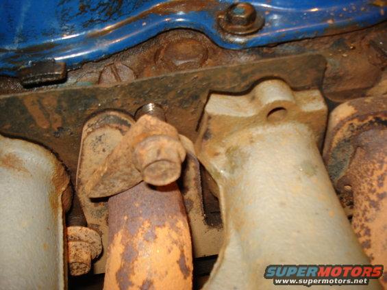 Close-up of rusty exhaust manifold bolts on an engine