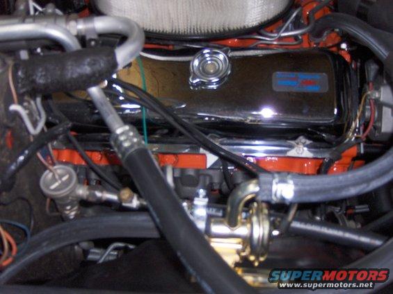 close-up of a car engine with chrome valve covers and air filter