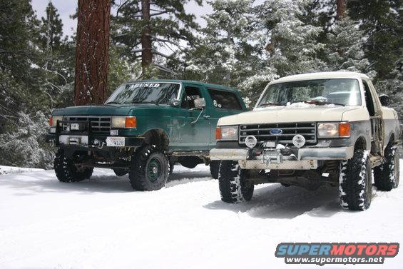 1991 Ford Bronco and a Ford F-Series truck in the snow
