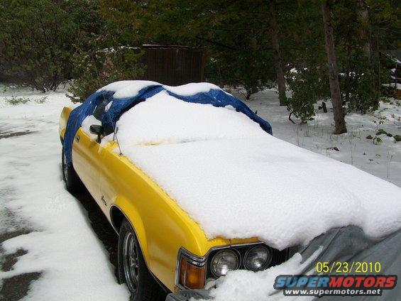 1972 Ford Ranchero covered in snow and a blue tarp