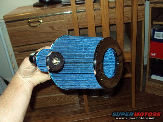 Blue cone air filter with chrome ends held in hand