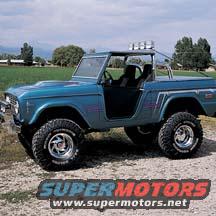 Blue 1970s Ford Bronco with off-road tires, roll bar, and roof lights, viewed from a 3/4 front angle