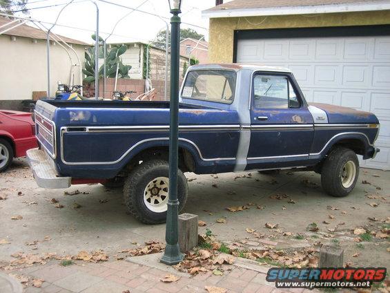 1979 Ford F-150 pickup truck parked in driveway, blue with silver trim