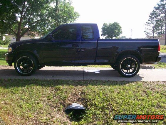 Side view of a 1997 Ford F-150 with custom wheels