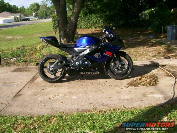 Blue and black 2006 Suzuki GSX-R 1000 motorcycle parked on concrete, side view