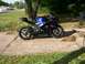 2006 Suzuki GSX-R 1000 - A blue and black Suzuki GSX-R 1000 motorcycle is parked outdoors on a concrete driveway.