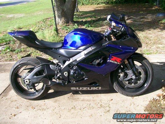Blue and black 2006 Suzuki GSX-R 1000 motorcycle parked on a concrete driveway, side view