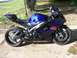 2006 Suzuki GSX-R 1000 - A blue and black 2006 Suzuki GSX-R 1000 motorcycle is parked outdoors on a concrete surface.