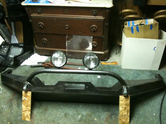 Custom steel bumper with two round lights and brush guard