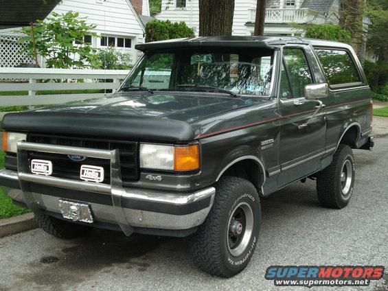 Dark gray 1988 Ford Bronco 3/4 front view with bull bar and aftermarket lights