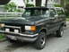 1988 Ford Bronco - This 1988 Ford Bronco features a chrome bull bar and aftermarket lights, presented in a 3/4 front view.