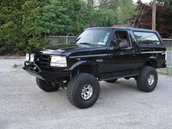 Black 1995 Ford Bronco with custom bumper and off-road tires