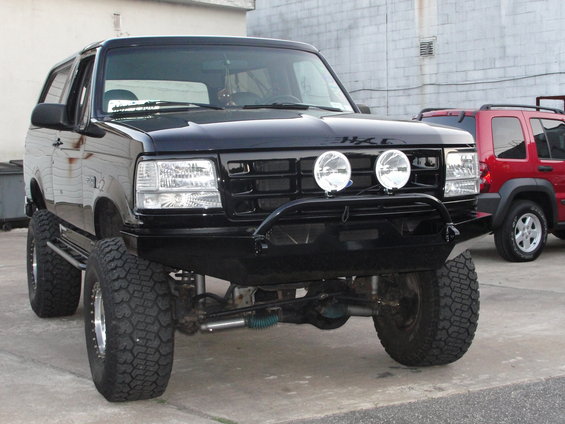 Black 1995 Ford Bronco front view with aftermarket bumper and lights