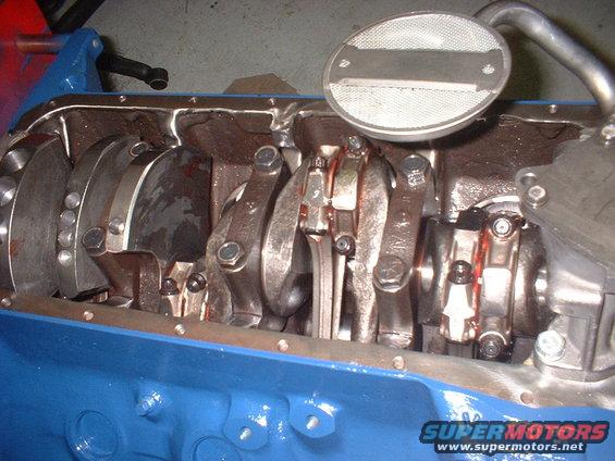 Engine crankshaft and connecting rods with oil pickup tube visible